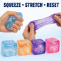 Adult hands squeezing and stretching glitter squeeze cubes with four colors displayed