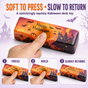 Adult hand pressing a Halloween butter squishy bar with slow-return demonstration