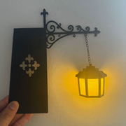 Vintage hanging bookshelf lantern glowing warmly in a dim room